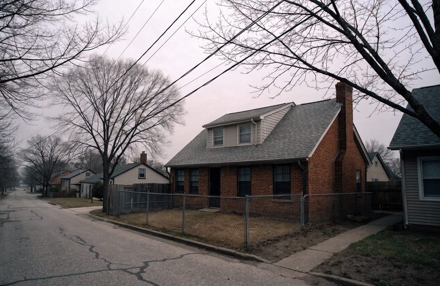 Post-war brick Cape Cod with a side chimney in a Baltimore County neighborhood